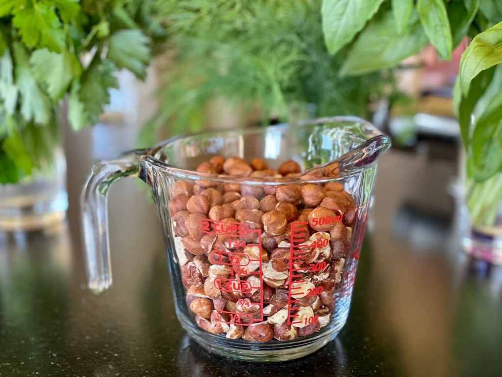 measuring cup filled with hazelnuts