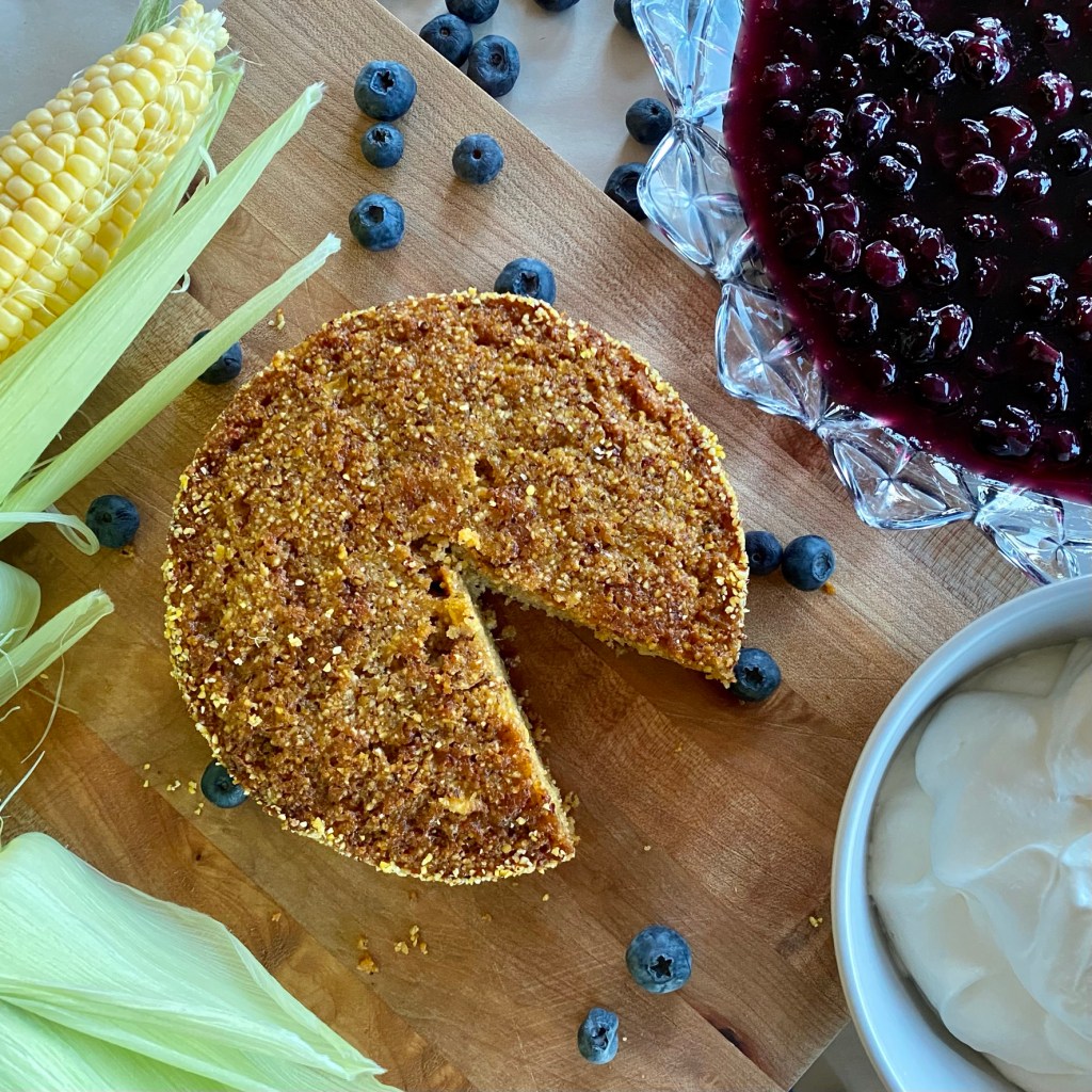 sweet corn buttermilk cake with bowl of blueberry compote