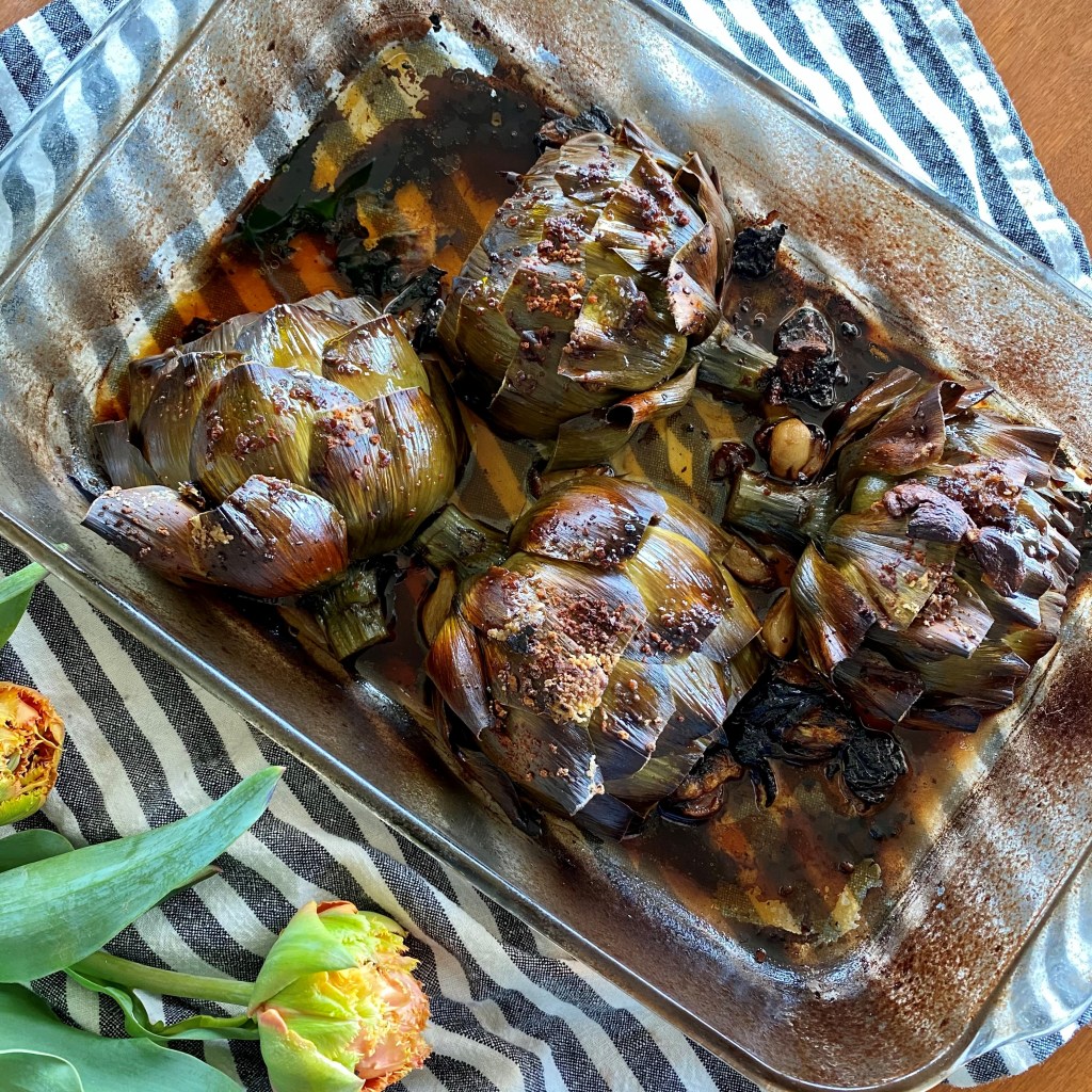 roasted artichokes in baking dish