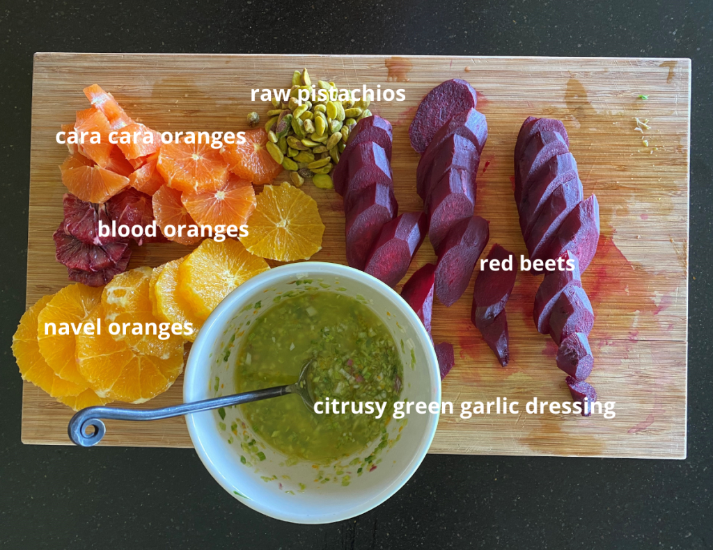 recipe ingredients of 3 kinds of oranges, sliced red beets, and green garlic sauce