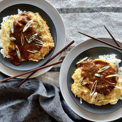 Top ten recipes of 2022- two plates of egg foo young with chopsticks.