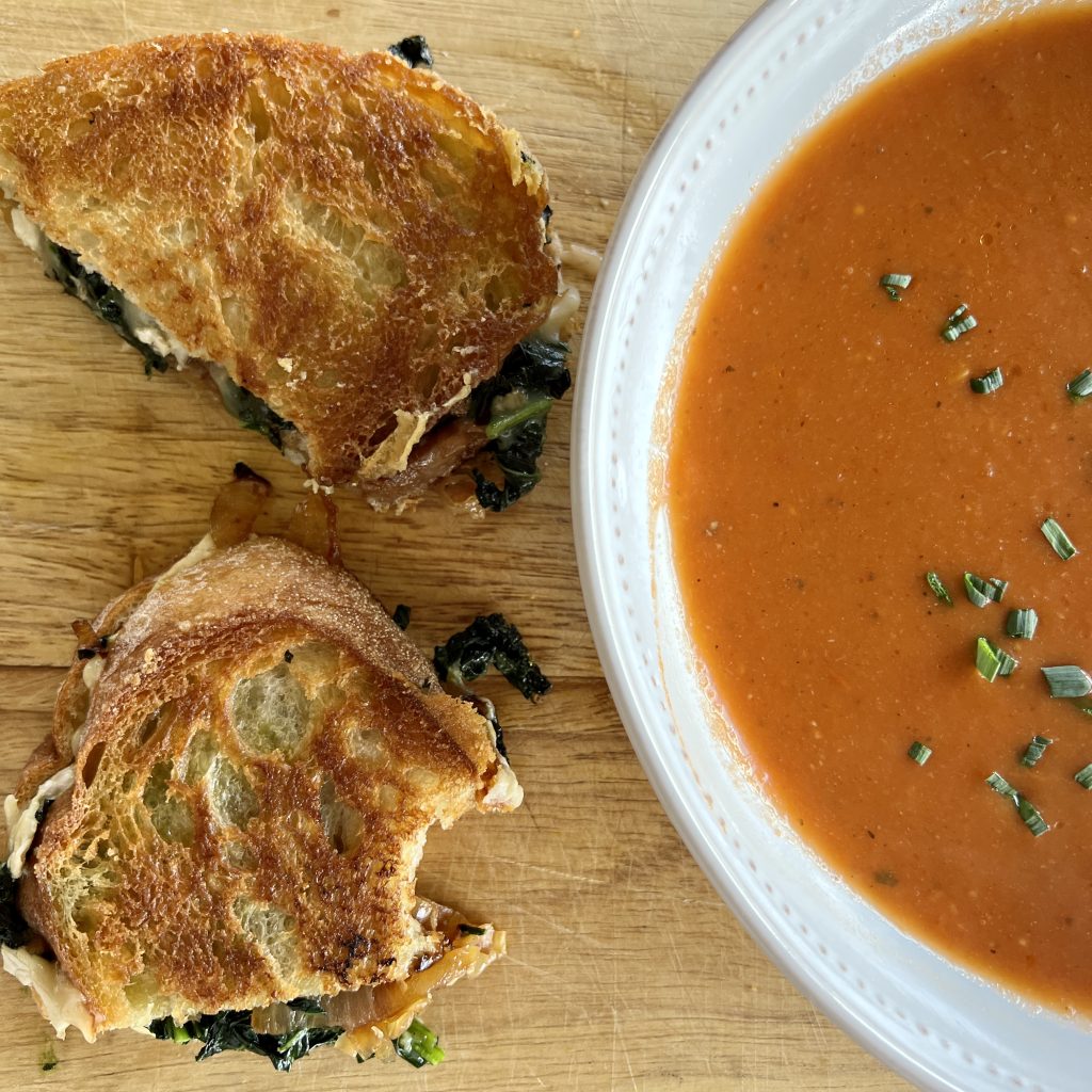 tomato soup with garlicky greens and brie grilled cheese sandwich