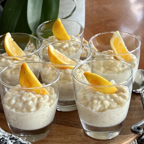 A platterful of cups of creamy vanilla lemon rice pudding.