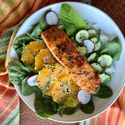 Sweet and spicy salmon bowl with orange and cucumber