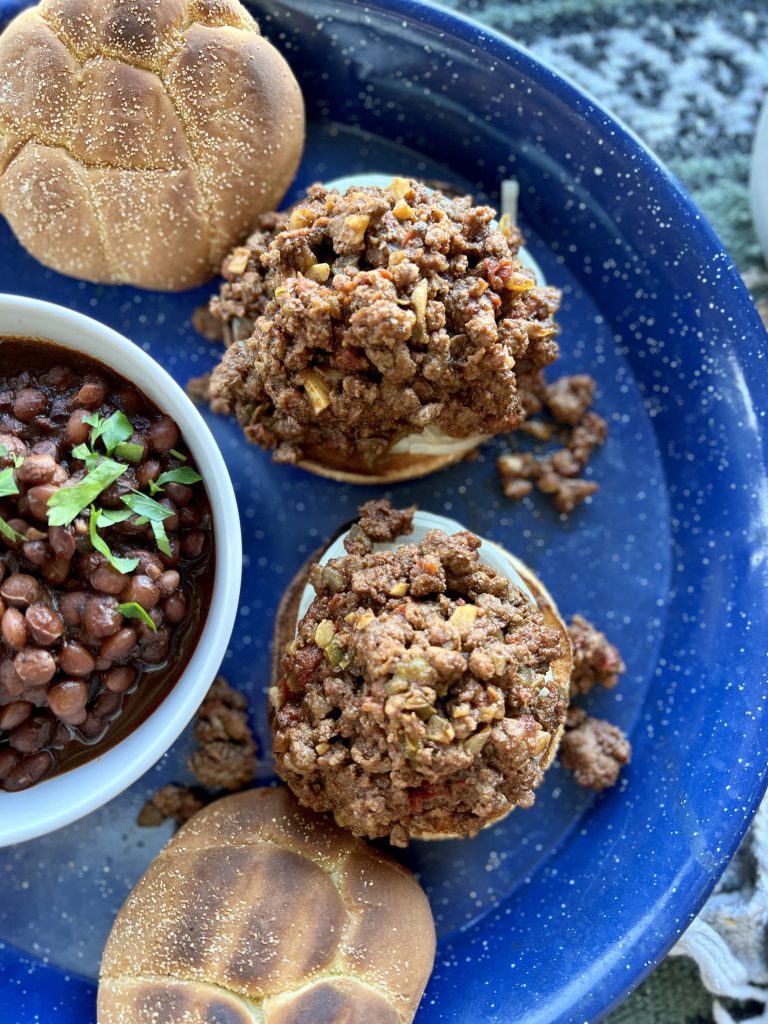 Cowboy sloppy joes on a platter with beans.