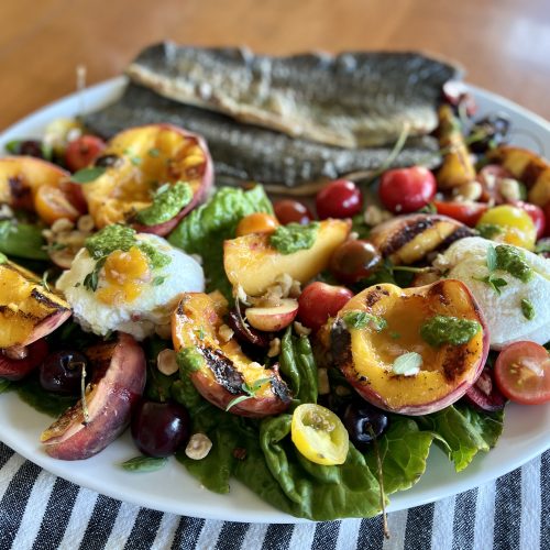 A platter of grilled peach + ricotta salad.