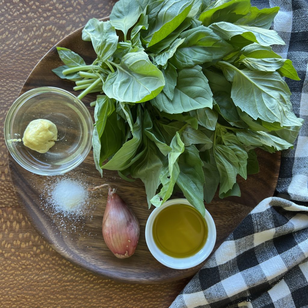 plate with the ingredients for basil sauce on it.