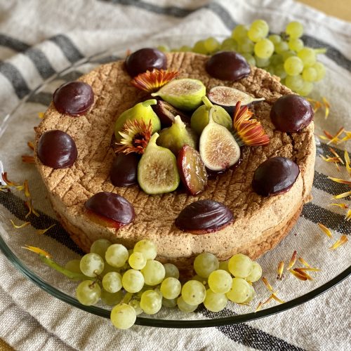 Flourless Walnut Cake, decorated with autumn fruits and flowers.