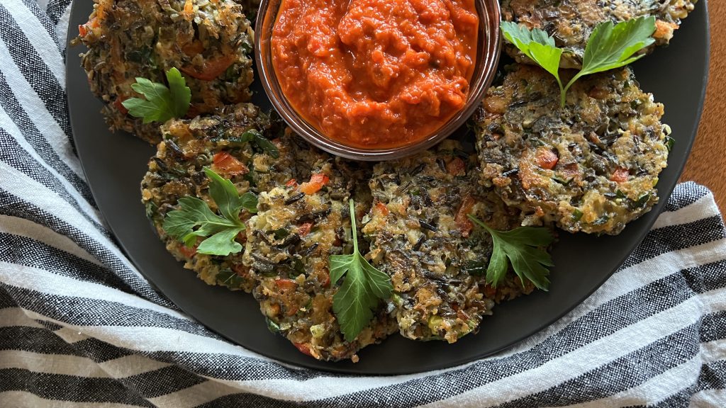 Colorful wild rice fritters and red pepper dip