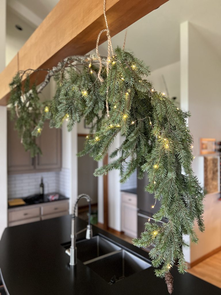 A fir bough hanging from kitchen rafters.